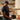 Man blending fruit in a Vitamix VX3 Blender in Black in a kitchen