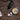 Black bamix hand blender on a dark wooden table beside garlic, chillies and an egg in a small bowl
