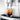 Jura E10 coffee spout pouring coffee into a glass