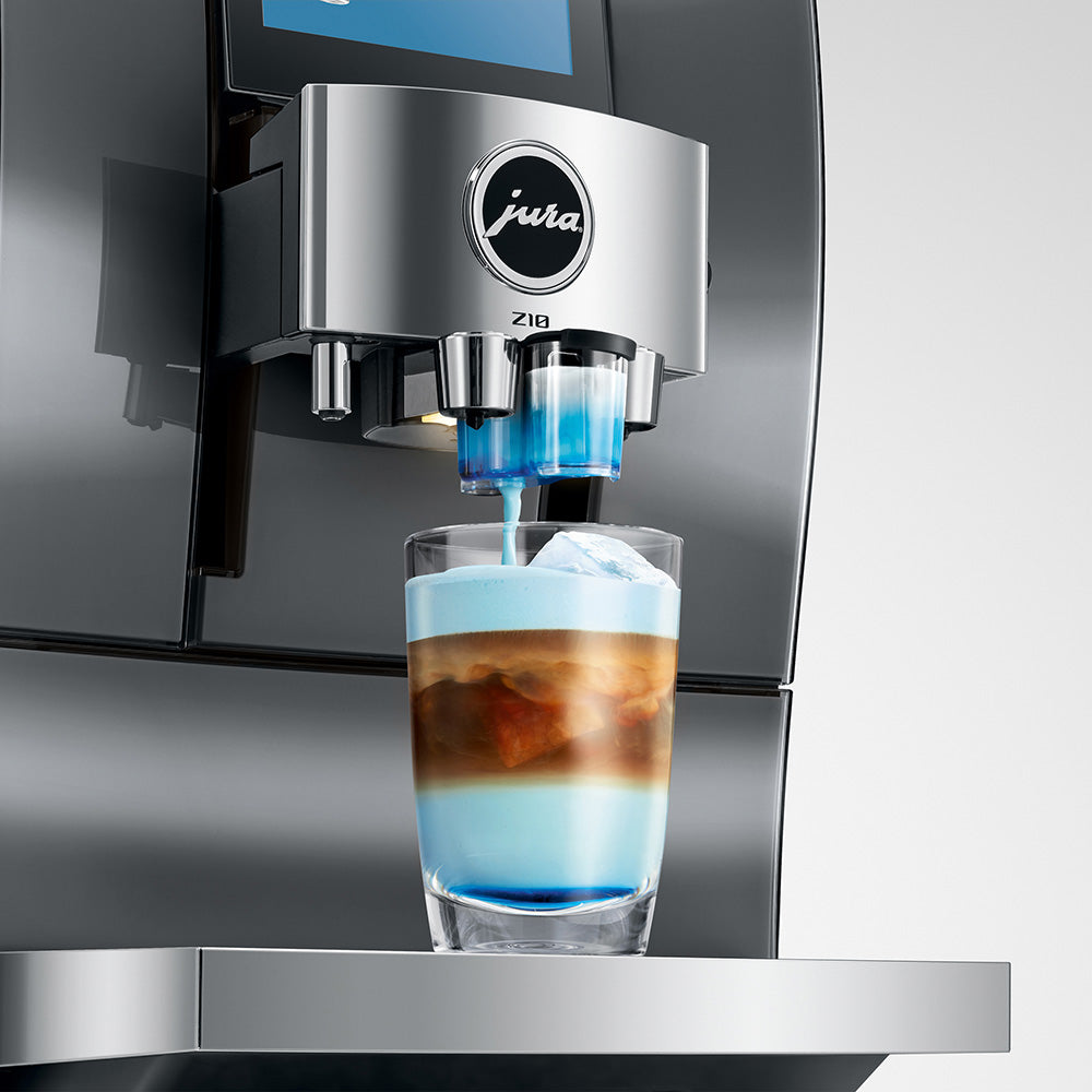 Jura Z10 Gen 2 Diamond Onyx with the syrup attachment fitted, topping a Cold Brew with sweet milk foam
