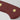 Close-up of the end of the Tasty Sumac handle of a WÜSTHOF CLASSIC knife, with its rivets and trident logo