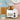 Dualit Classic 2-slice toaster in white with toast, a teal mug and a wooden board in a pastel kitchen