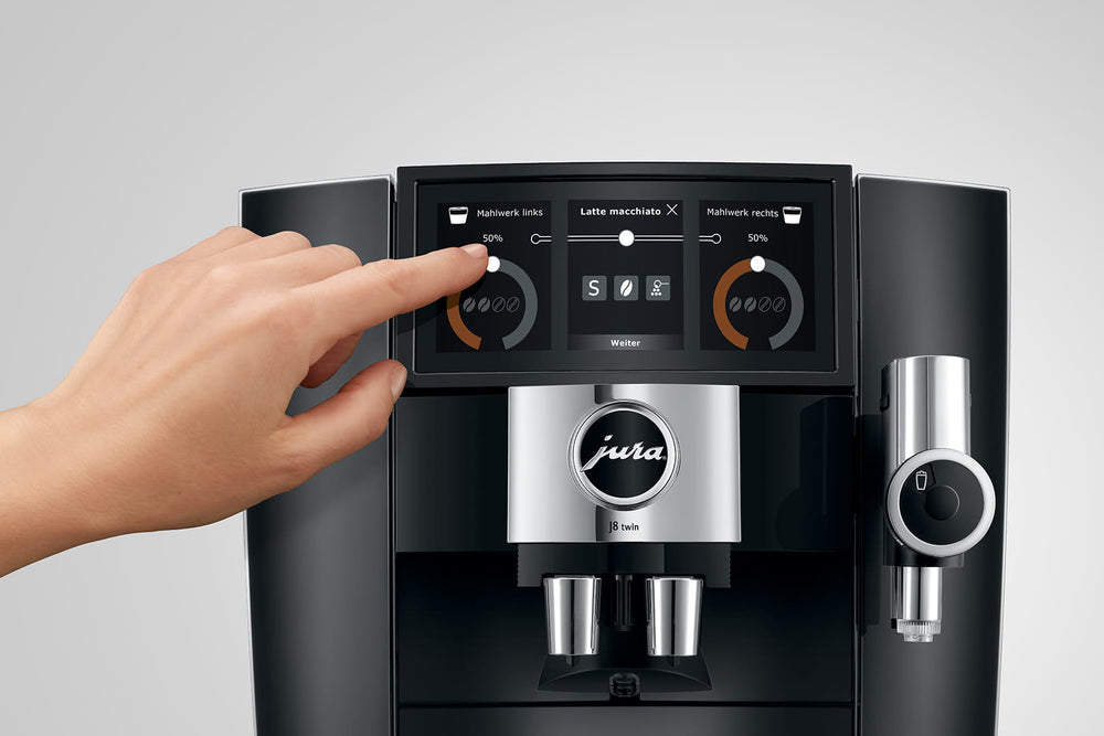 Jura J8 twin in Diamond Black, a finger selecting a setting on the Panorama Coffee Panel
