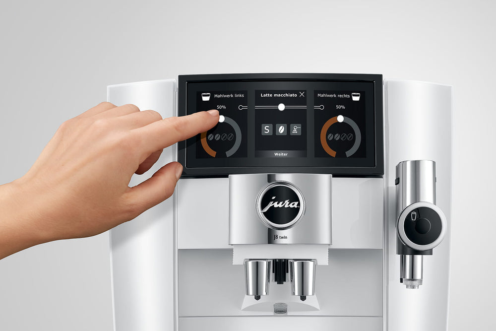 Jura J8 twin in Diamond White, a finger selecting a setting on the Panorama Coffee Panel