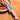 WÜSTHOF Junior 4" Chef's Knife, Pink, on a wooden table beside a bowl of strawberries and banana