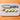 WÜSTHOF Junior 4" Chef's Knife, Blue, on a board with cucumber slices laid out as a snake