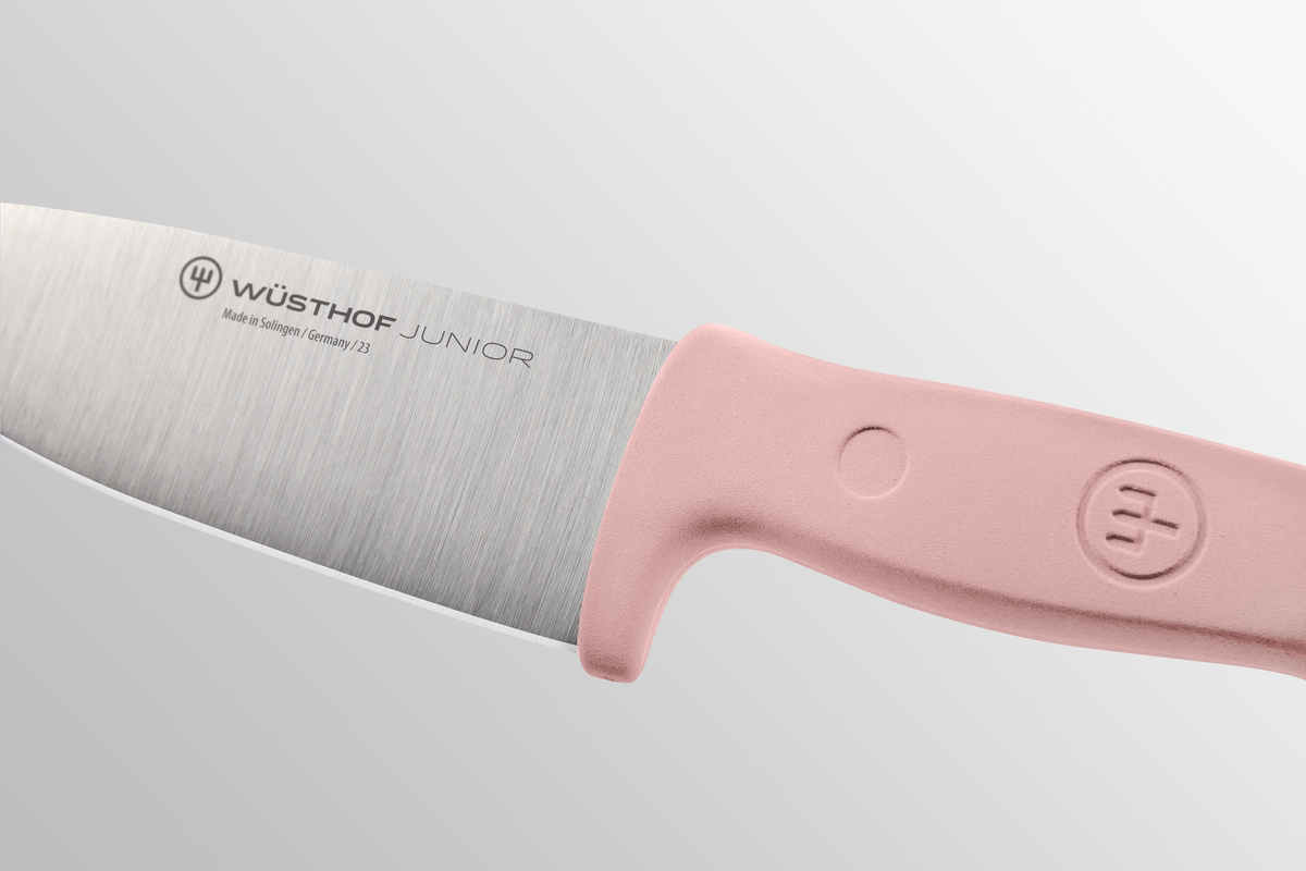 Close-up of the blade and pink handle of the WÜSTHOF Junior 4" Chef's Knife