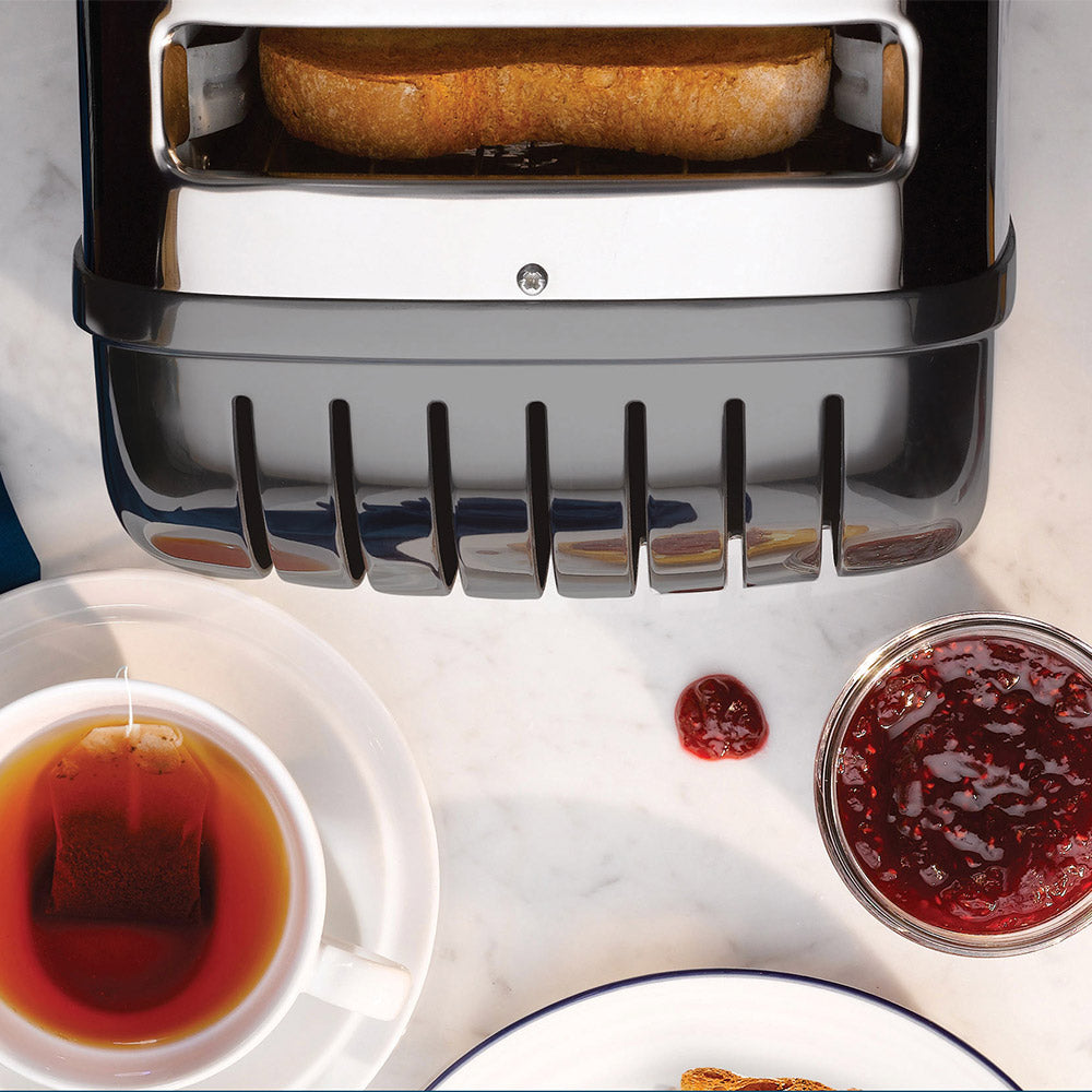 Dualit Classic 2-slice toaster in metallic charcoal seen from above with toast, tea and jam on a marble table