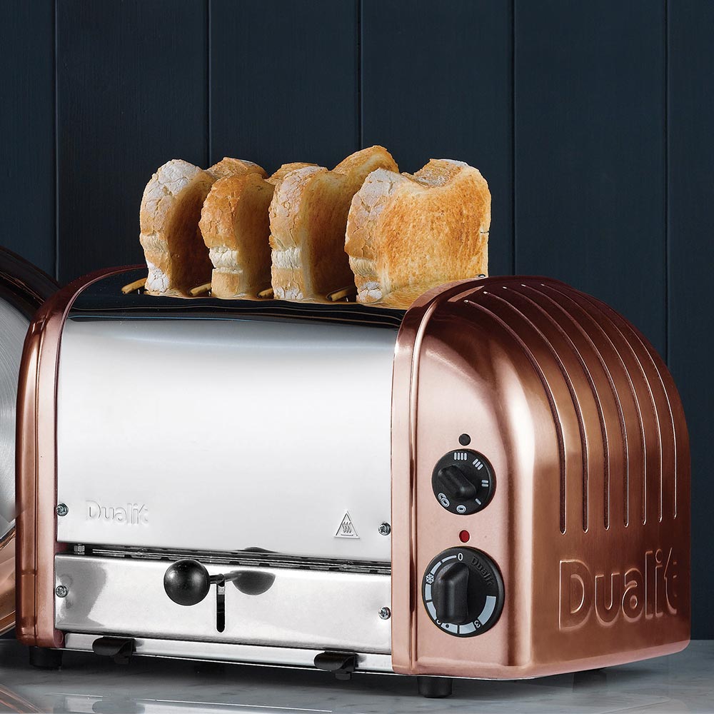 Dualit Classic 4-slice toaster in copper with toast against a navy panelled wall