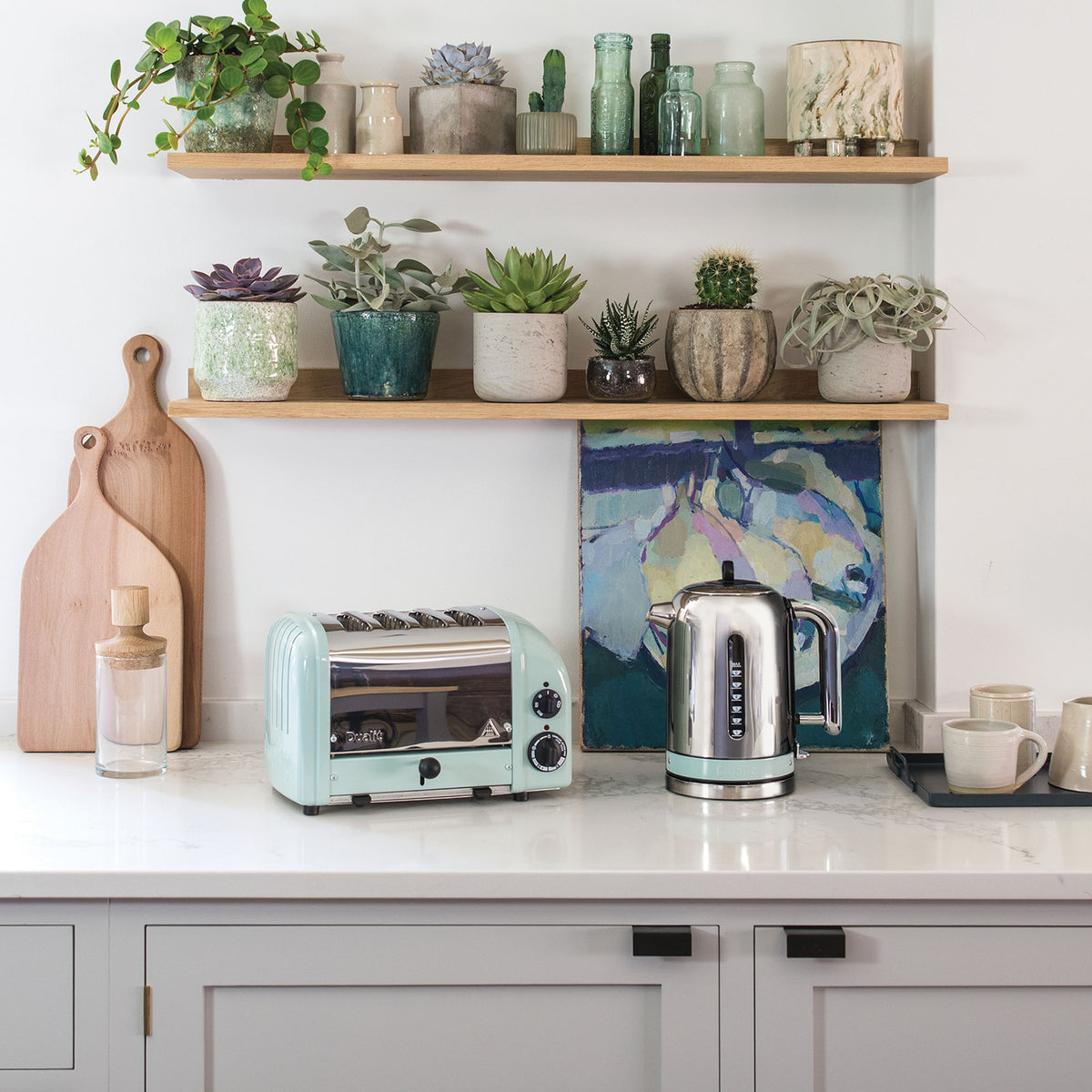 Dualit Classic 4-slice toaster in eucalyptus beside a Classic kettle in a white kitchen with succulents