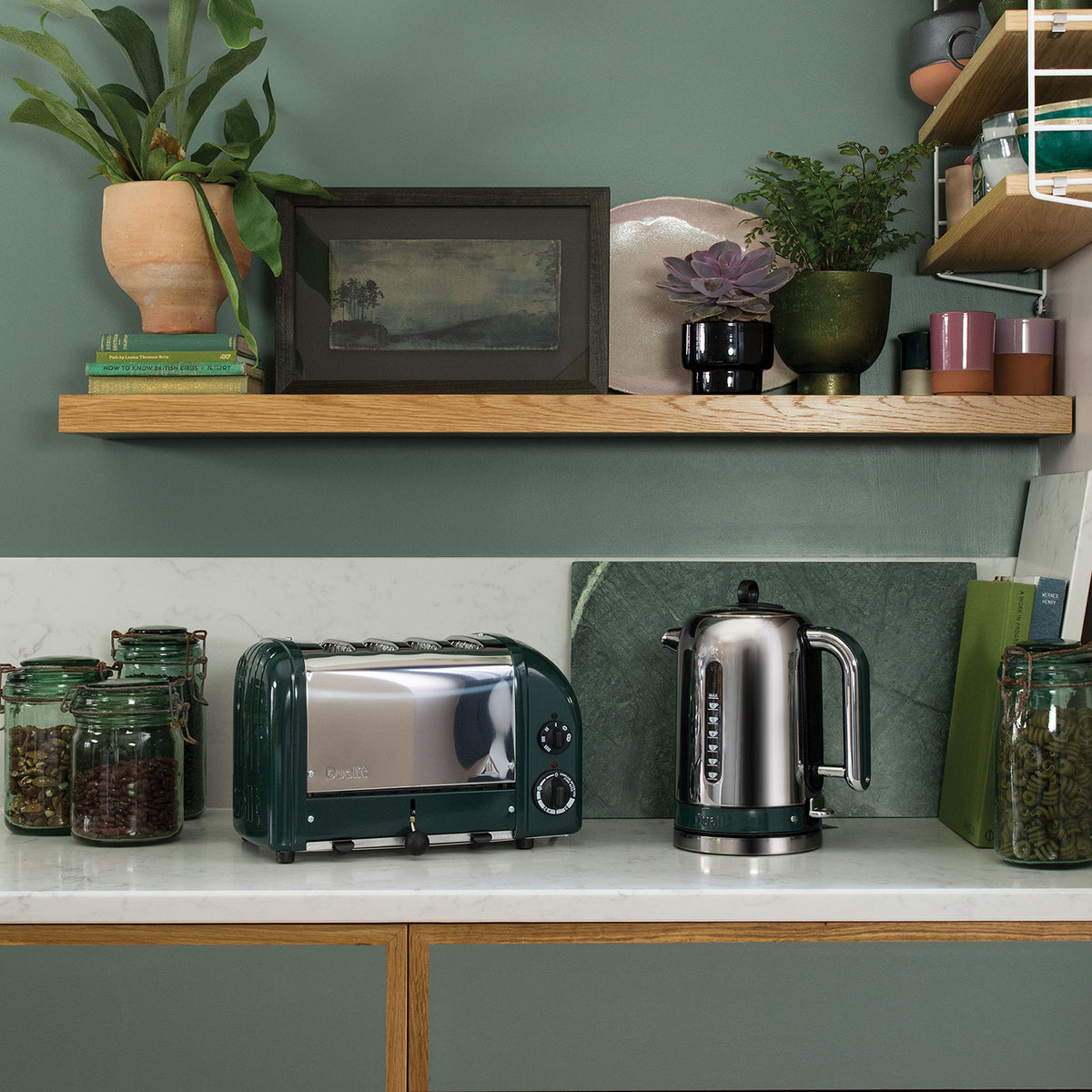 Dualit Classic 4-slice toaster in evergreen beside a Classic kettle and jars of tea in a green kitchen