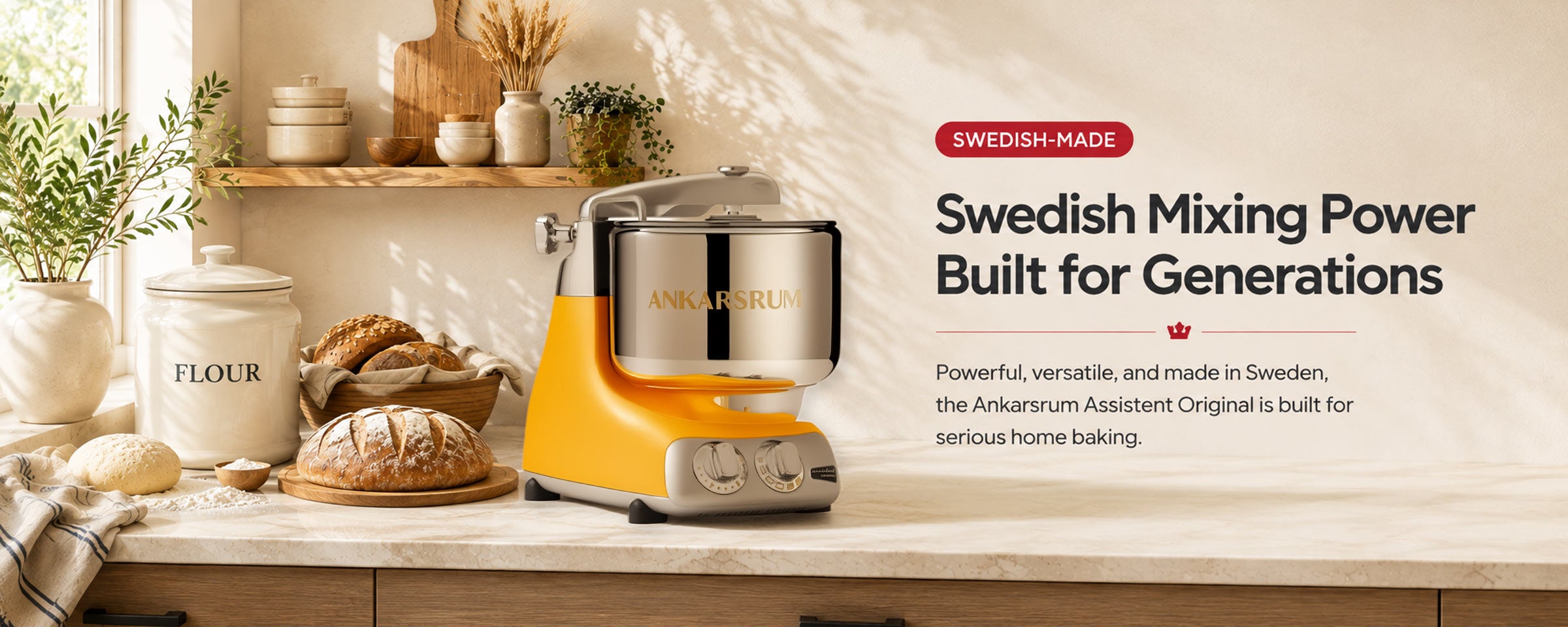 A yellow and stainless steel Annarum Assistent Original mixing machine displayed on a kitchen counter with bread, flour, and decorative items, alongside promotional text highlighting its Swedish-made quality.