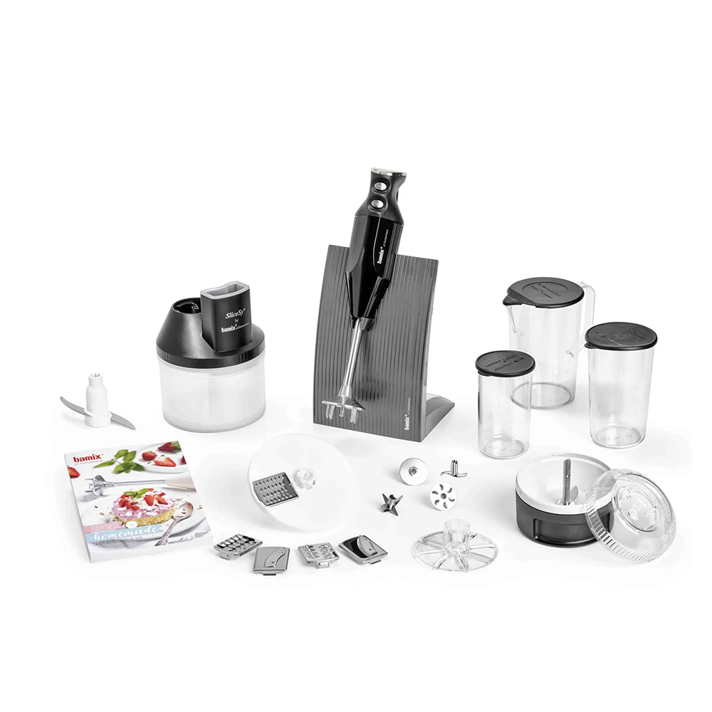 bamix BAKING set laid out on white: hand blender in its stand, Processor, SliceSy, beakers, discs and recipe book