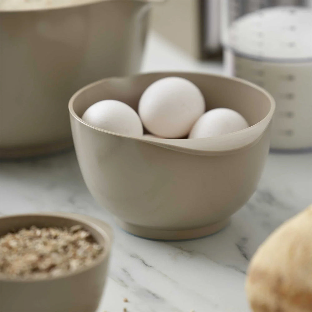 Rosti Margrethe 3L mixing bowl in Humus holding eggs on a marble counter