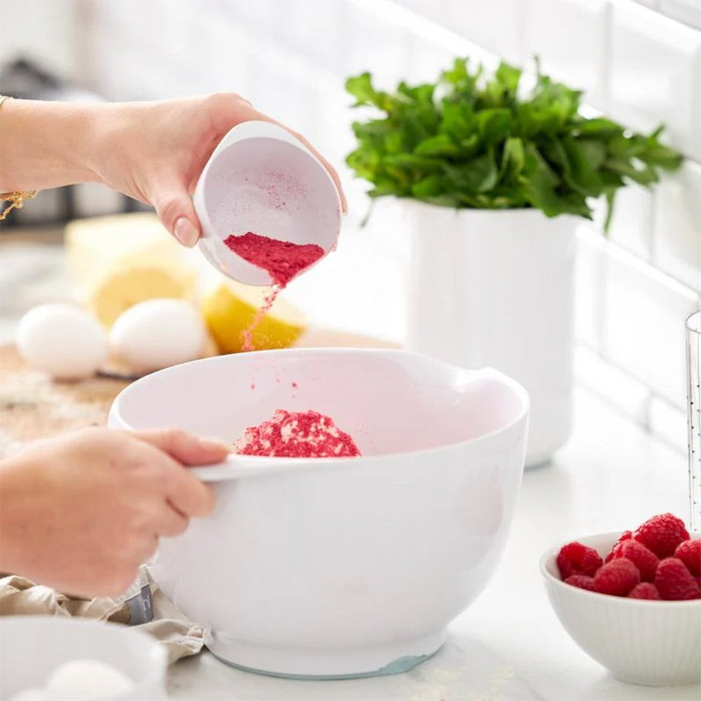 Raspberry powder poured into a white Rosti Margrethe mixing bowl