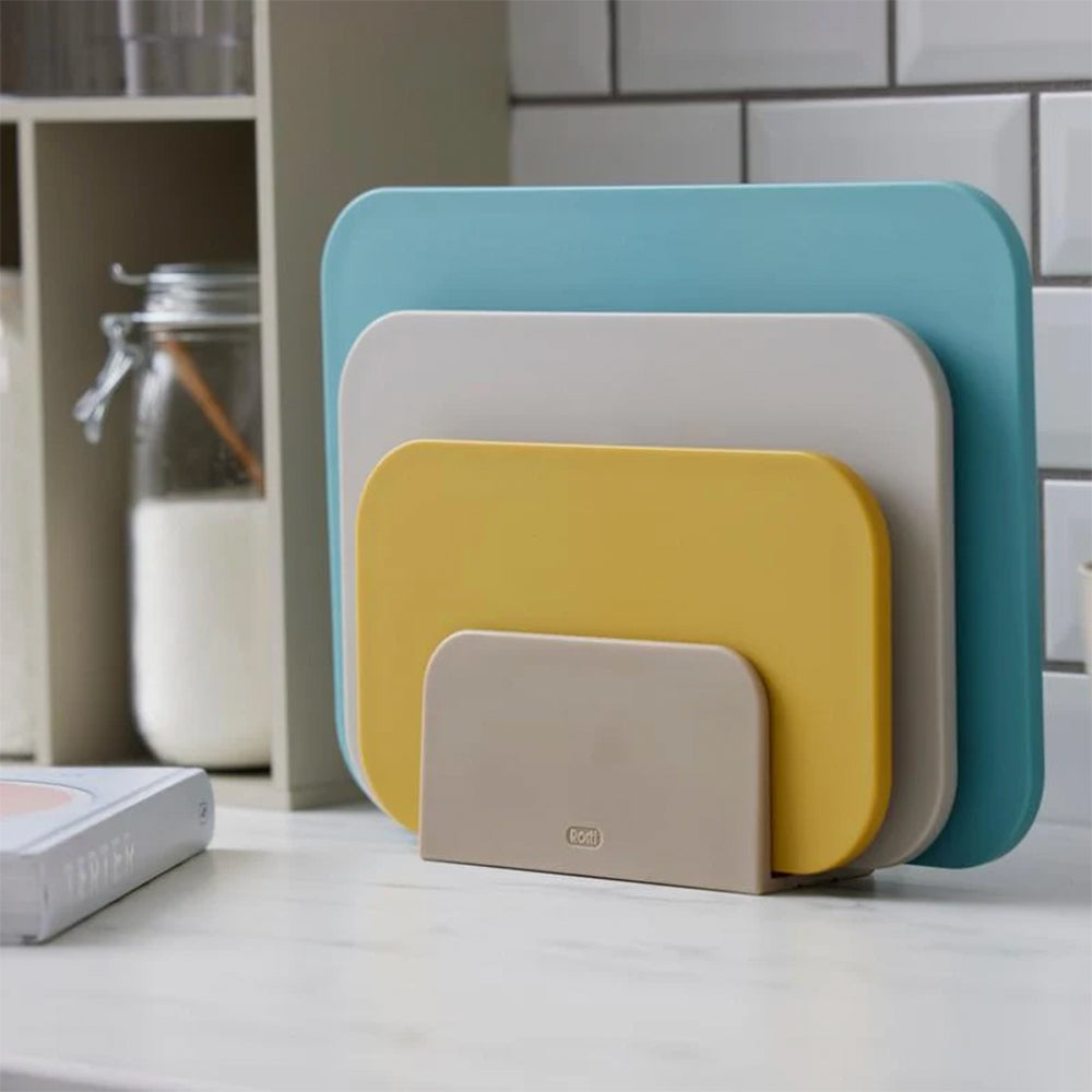 Rosti Choptima cutting boards standing in their stand on a kitchen counter
