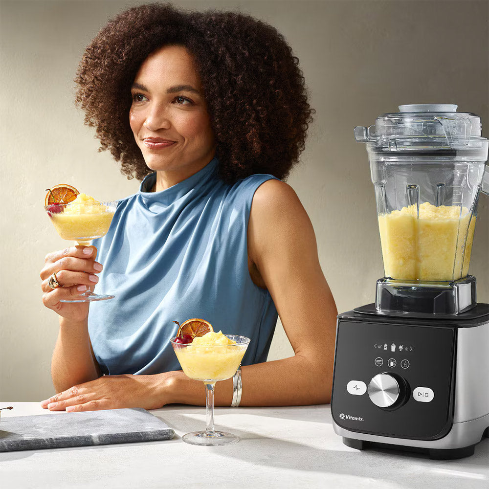 Woman with frozen cocktails beside a Vitamix Ascent X5 Blender in Brushed Stainless