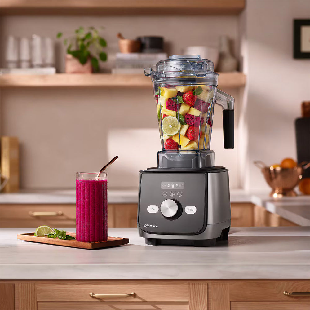 Vitamix Ascent X5 Blender in Graphite with fruit and a pink smoothie in a kitchen