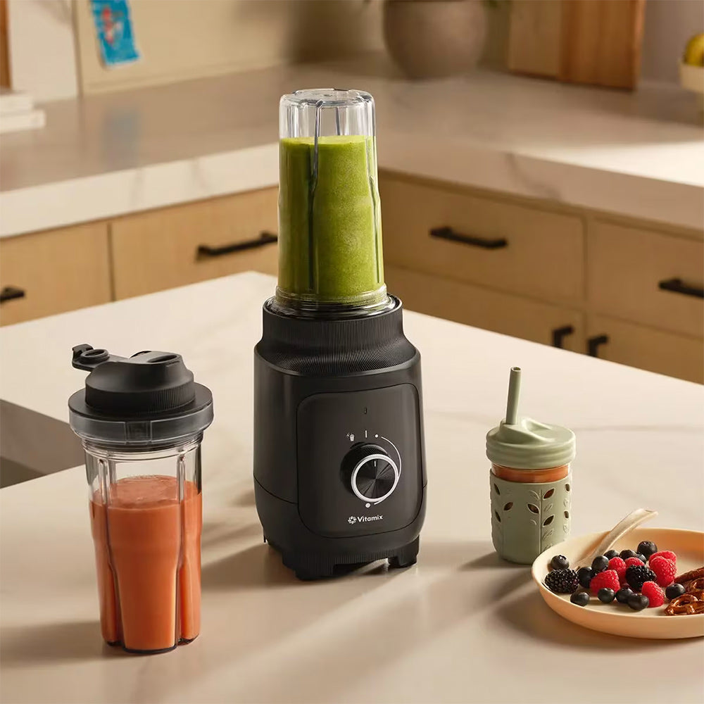 Vitamix Nano Personal Blender in Black with a green smoothie in a kitchen