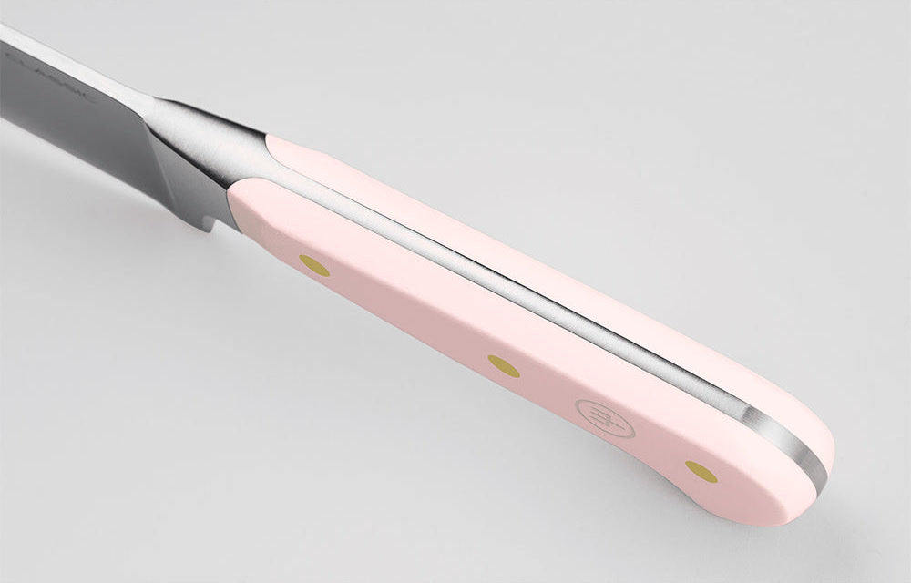 Close-up of the Pink Himalayan Salt handle of a WÜSTHOF CLASSIC knife from the spine side, showing the tang