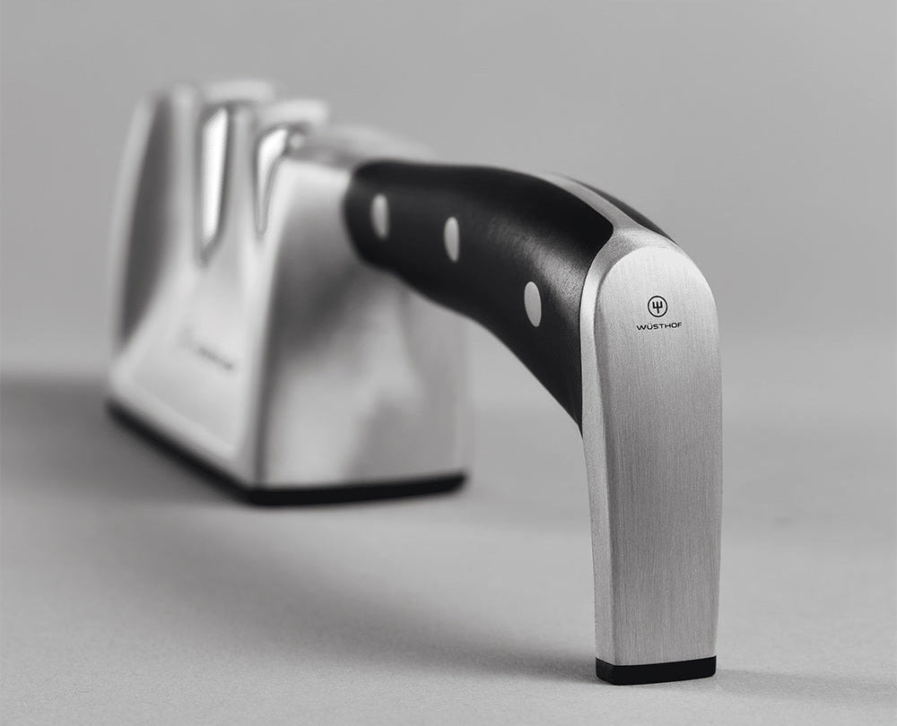 WÜSTHOF CLASSIC IKON 2-Stage Hand-Held Sharpener seen from the handle end, on a grey surface