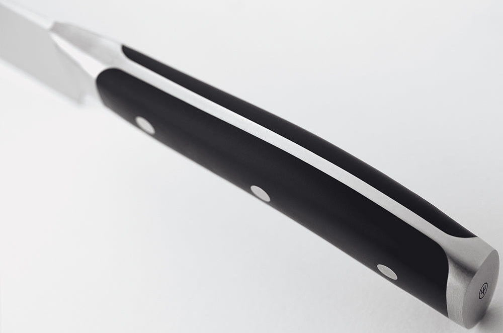 Close-up of the black handle of a WÜSTHOF CLASSIC IKON knife from the spine side, showing the tang