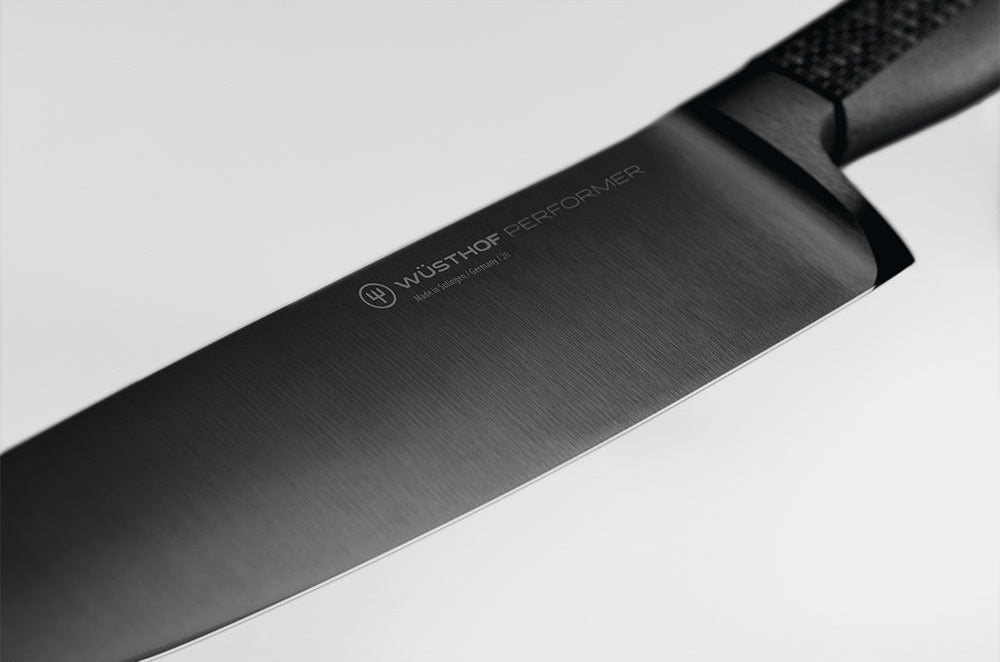 Close-up of the black blade and logo of a WÜSTHOF PERFORMER knife