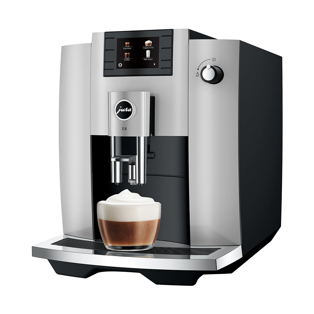Jura E6 in Platinum, angled to the left, with a cappuccino