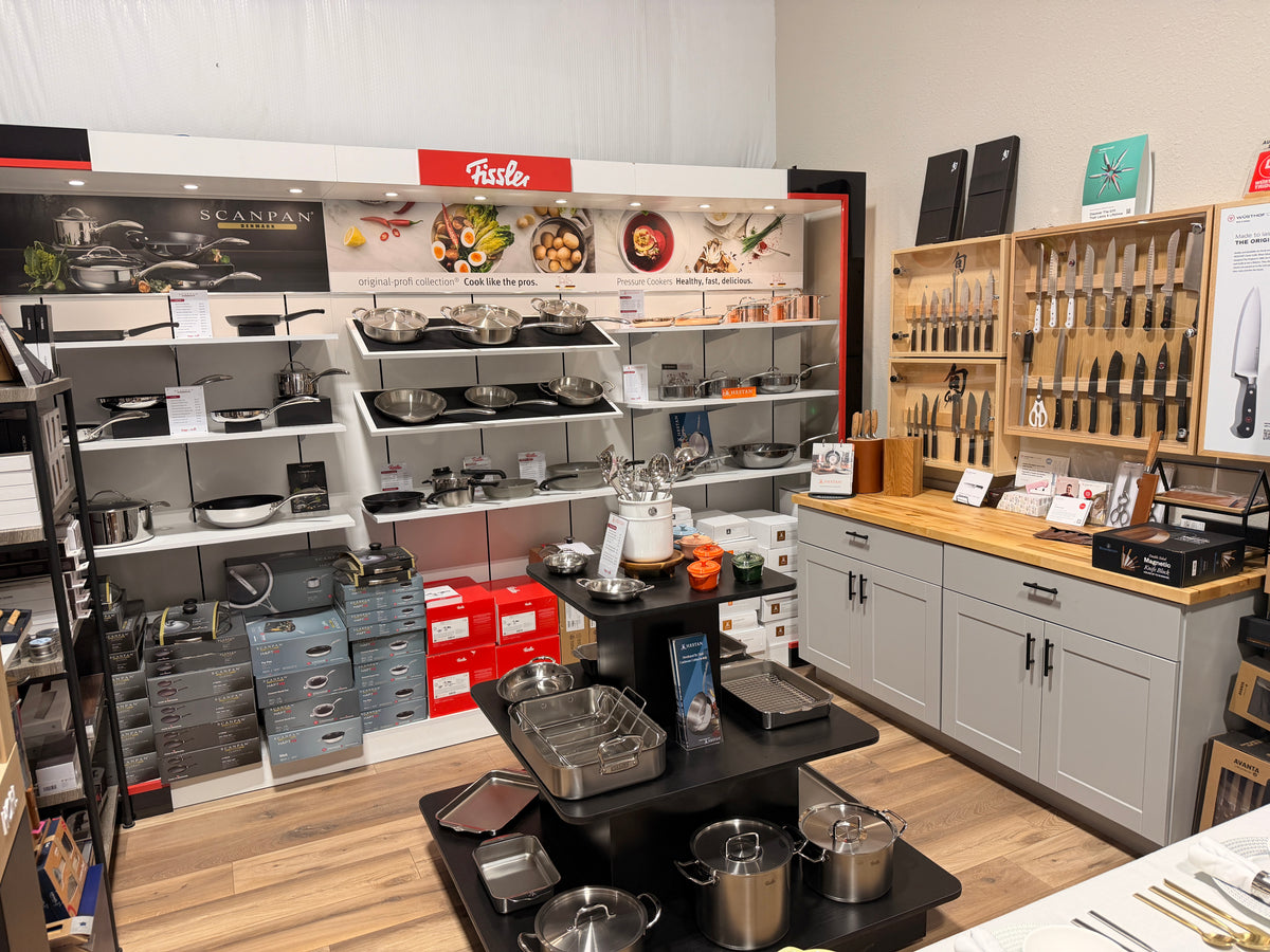 Fissler, Scanpan and Hestan cookware shelves beside the knife cabinets at the Design & Grace store in Argyle, Texas