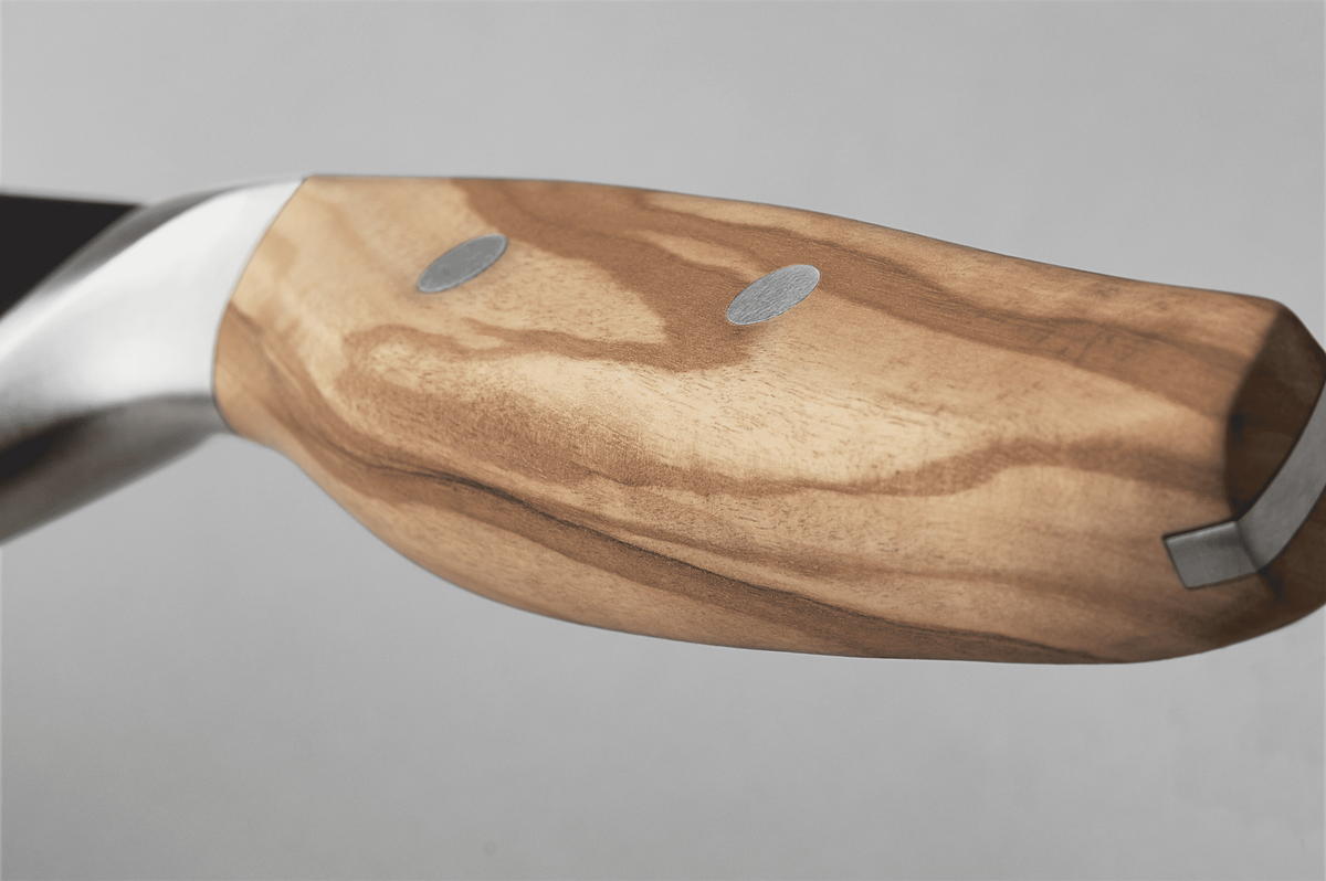 Close-up of the wooden handle of a WÜSTHOF AMICI knife, with its rivets