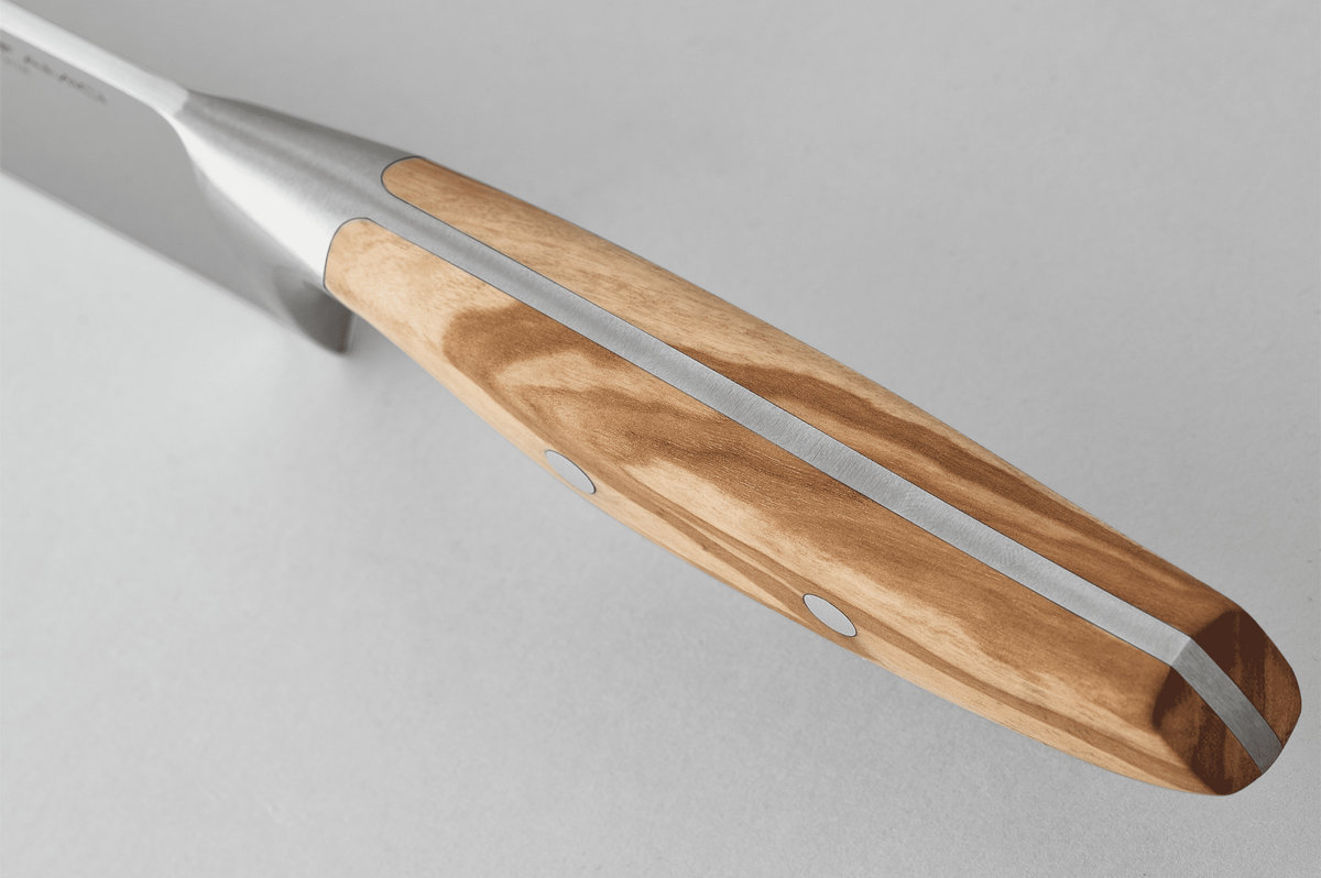 Close-up of a WÜSTHOF AMICI handle from the spine side, showing the tang running through the wood