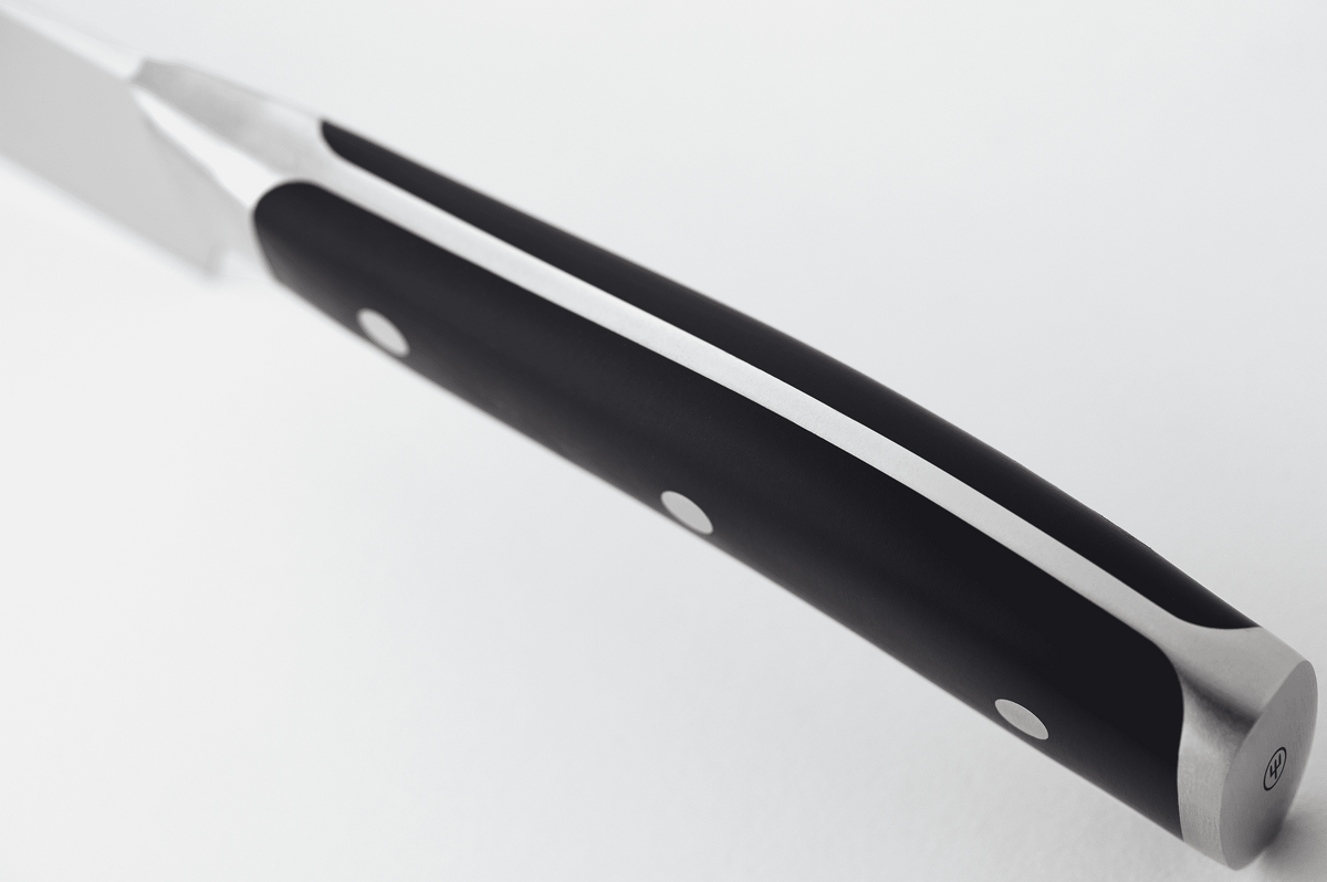 Close-up of the black handle of a WÜSTHOF CLASSIC IKON knife from the spine side, showing the tang