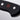 Close-up of the end of the black handle of a WÜSTHOF CLASSIC knife, with its rivets and red trident logo