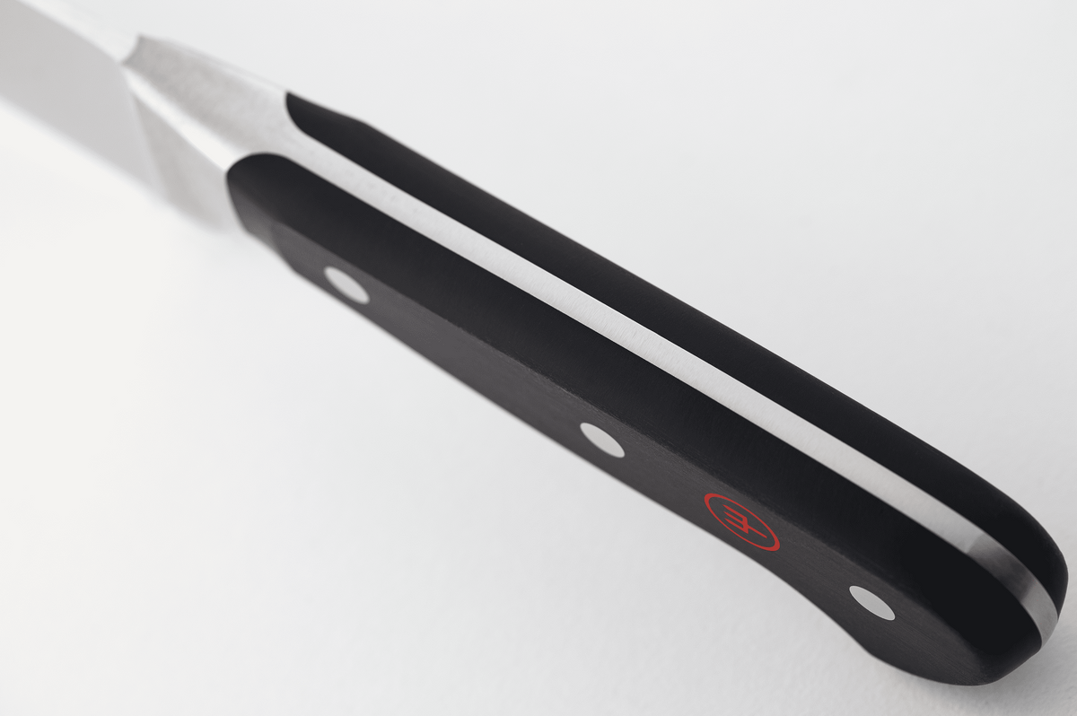 Close-up of the black handle of a WÜSTHOF CLASSIC knife from the spine side, showing the tang