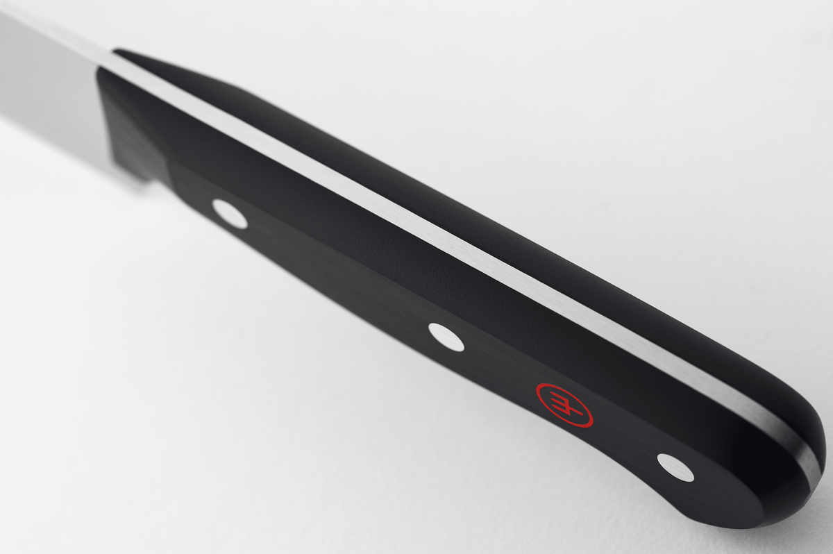 Close-up of the black handle of a WÜSTHOF GOURMET knife from the spine side, showing the tang