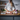 Woman chopping vegetables at a kitchen counter with a WÜSTHOF GOURMET knife, beside a knife block