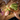 Hands chopping romaine lettuce with a WÜSTHOF GOURMET chef's knife on a wooden board, beside red cabbage