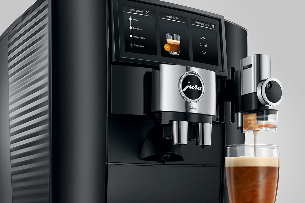 Jura J8 twin in Diamond Black, close-up on a gray background, Panorama Coffee Panel and a coffee being prepared