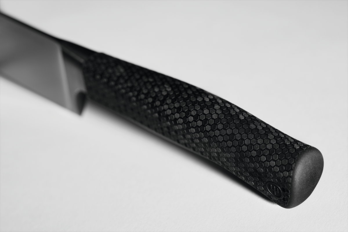 Close-up of the textured black handle of a WÜSTHOF PERFORMER knife