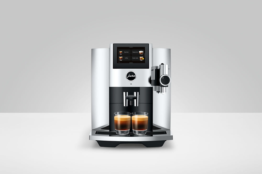Jura S8 in Chrome, front view on a gray background, with two espressos