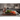 Chef's knife on a dark wooden board with rainbow chard, with a WÜSTHOF sharpening steel and knife block in a kitchen
