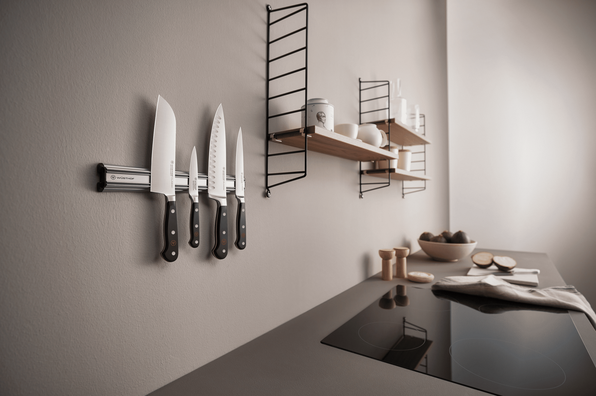 WÜSTHOF CLASSIC knives on a silver wall bar in a modern grey kitchen