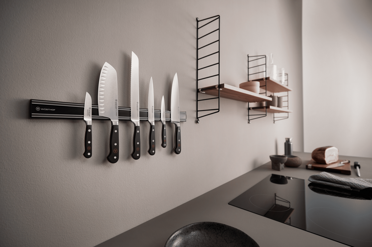WÜSTHOF CLASSIC knives on a black WÜSTHOF wall bar in a modern grey kitchen